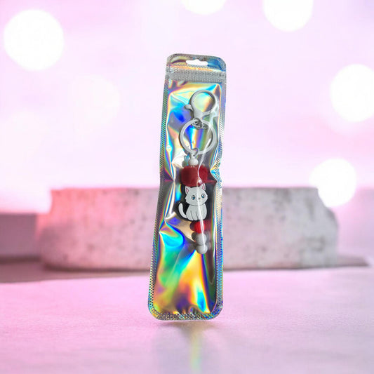 white and red cat keyring